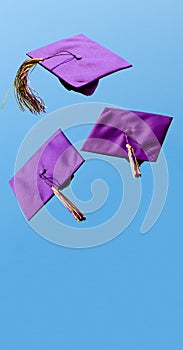 Graduation caps flying in the air