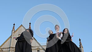 Graduation caps thrown in the air.