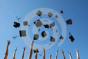 Graduation Caps Thrown in the Air on blue sky