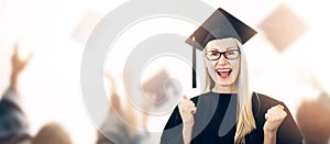 Graduation - happy graduate wearing gown and hat