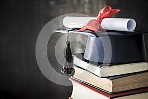 Graduation hat and diploma on table