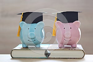 Graduation hat on piggy bank and a books on white background, Saving money for education concept