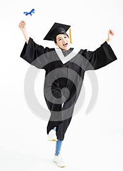 Graduation student dancing and showing diploma