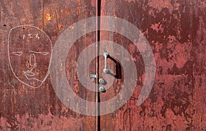 Graffit and peeling paint on old red steel door