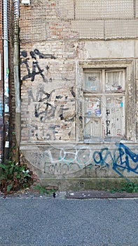 graffiti on abandoned house with nailed windows