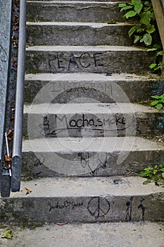 Graffiti-Adorned Urban Stairs with Social Messages, Ascending View