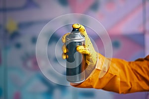 Graffiti artist pointing spray paint can to camera