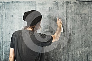 Graffiti artist spraying the wall