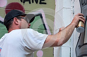 Graffiti Artist At Work On Mural