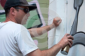 Graffiti Artist At Work On Mural