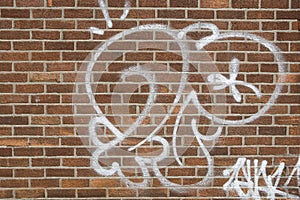 Graffiti on a brown brick wall