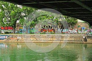 Graffiti covered banks of Danube Canal Donaukanal under Aspern Bridge AspernbrÃ¼cke, Vienna Wien, Austria Ã–sterreich