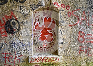 Graffiti covered stone wall along trail from La Turbie to Tete de Chien, southeastern France.