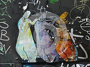 Graffiti depicting three figures standing next to each other.
