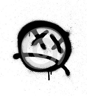 Graffiti emoticon face sprayed in black on white photo
