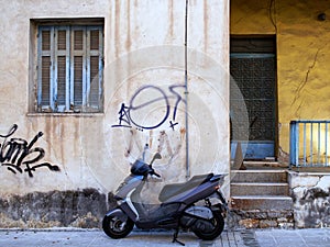 Graffiti on Old Stucco Building and Motor Scooter