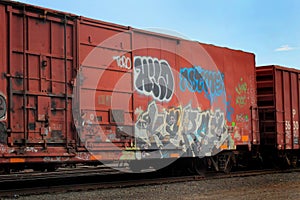 Graffiti on a red railroad car