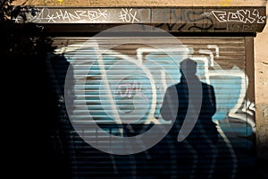 Graffiti and shadow of man
