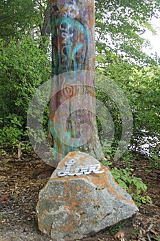 graffiti tree with rock and sign reading LOVE, spread love not hate