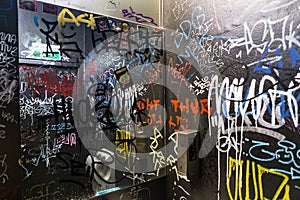 Graffiti vandalism tag writing indoor WC toilet restroom wall text color photo