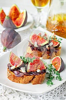 Grain baguette sandwiches with figs, feta cheese, red onion marmalade and thyme . Delicious snack for gourmands
