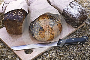 Grain bread on a wooden board outdoors