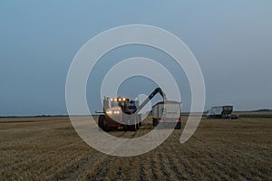 Grain cart unloading grain into a semi truck