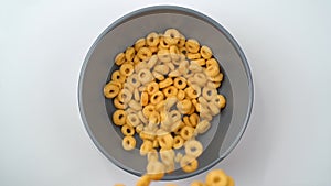 Grain cheerios cereal falling into the bowl