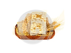 Grain crackers, biscuits and grains of wheat on white background