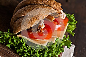 Grain croissant sandwich on a whiteboard and a dark background