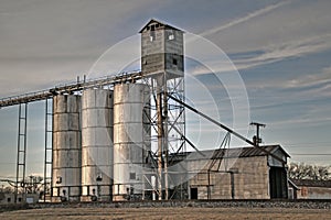 Grain Elevator alongside railroad tracks in small town in Texas.