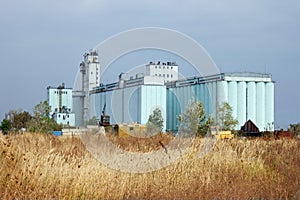 Grain elevator rises among the steppe