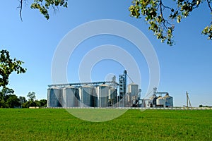 Grain elevator silos. Agriculture factory. Storage tanks agricultural crops processing plant