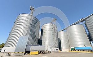 Grain elevator silos closeup with blue sky on the background