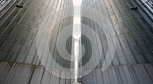 Grain elevator silos closeup with blue sky on the background