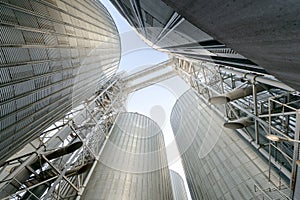 Grain elevator silos closeup with blue sky on the background