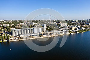 Grain elevator and silos near the river aerial view.