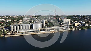 Grain elevator and silos near the river aerial view.