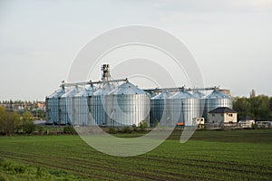 Grain elevators among spring landscape