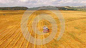 Grain Harvester Standing In Yellow Wheat Field