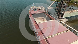 Grain loading terminal. Agriculture a transportation business concept. Grain barge boat tugboat. Loading grain on water