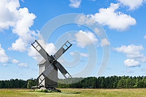 Grain mill on the winter landscape. Windmill and natural background