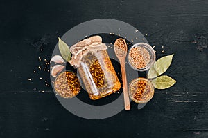 Grain Mustard. Spices On a dark wooden background.