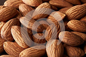 Grain scattered handful of almonds close up