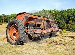 Grain seeder stands on the edge of the field