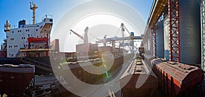 Grain from silos being loaded onto cargo ship on