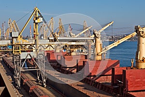 Grain from silos being loaded onto cargo ship on