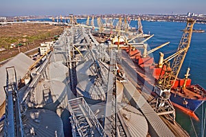 Grain from silos being loaded onto cargo ship on