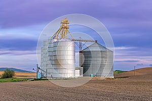 Grain silos and bins at sunset in Palouse Hills, Washington