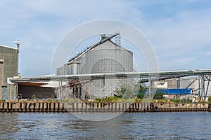 grain silos are  located in a transhipment port photo